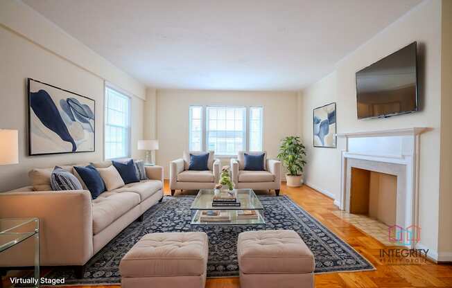 A living room with a fireplace and a TV mounted on the wall.