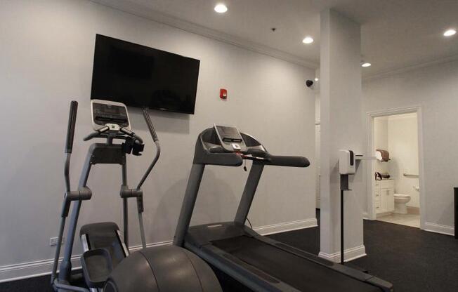 a gym with two machines and a tv on the wall at Tripp 4321, Chicago, 60641