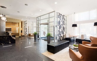 the lobby of a hotel with chairs and couches