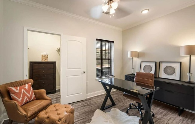 a living room with a desk and a chair  at Arlo Luxury homes Apartments, Little Rock, AR,72210