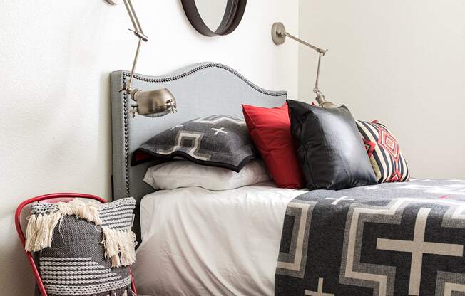 a bedroom with a bed and a red chair