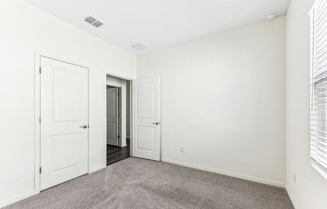 Bedroom with white walls of Dogwood floor plan at Beacon at Presidential Heights in Manor, TX