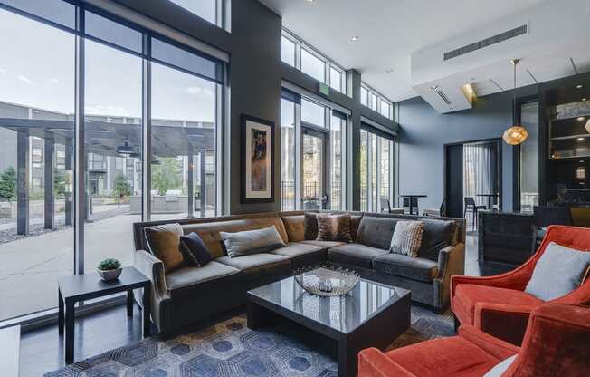 Community room with a variety of seating looking towards floor-to-ceiling windows