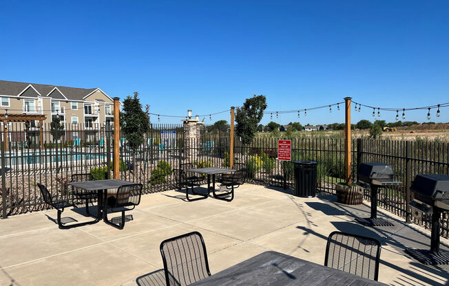 Grilling Area with Seating at Copper Creek Apartment Homes in Maize, Kansas