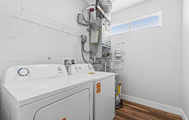A white washing machine and dryer in a small laundry room.