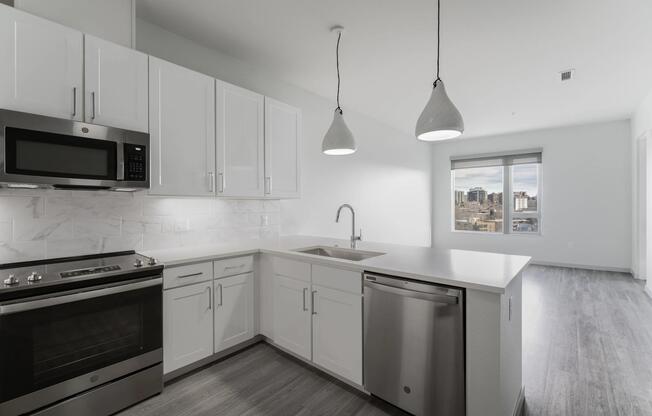Open concept kitchen with marble backsplash and pendant lighting