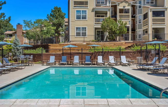 our apartments have a swimming pool with chairs and umbrellas at Arcadia Apartments, Colorado