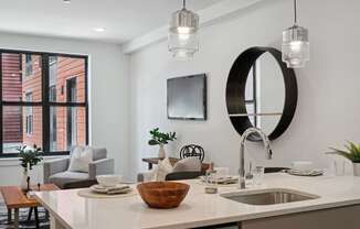 Kitchen and living room with white walls and a large window  at The Anchorage on Kelly, East Falls, PA