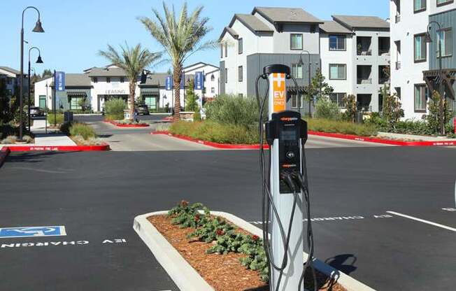 A parking lot with a charging station for electric vehicles.