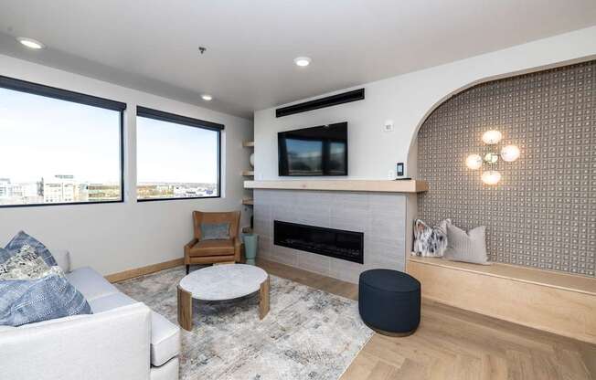 A modern living room with a fireplace and a flat screen TV.