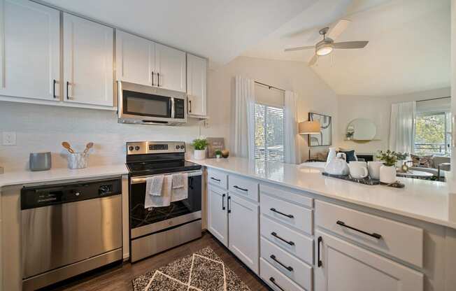 a kitchen with stainless steel appliances and white cabinets at Bay Village, Vallejo, 94590