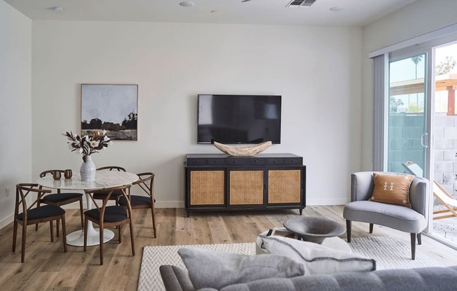 a living room with a couch and a table and a television at Novella Biltmore, Arizona, 85016