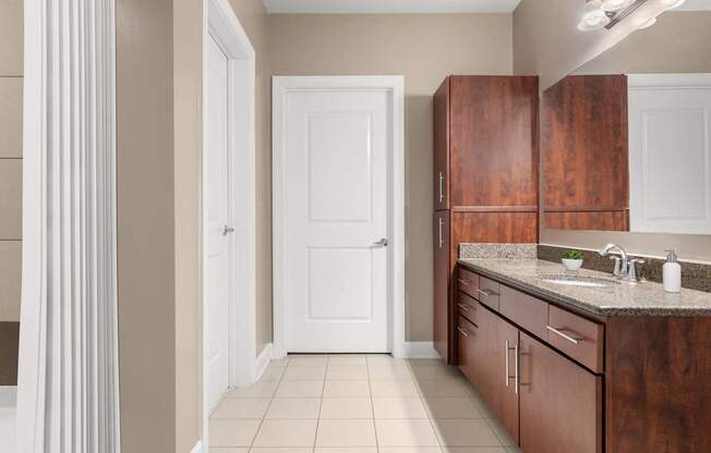 A kitchen with brown cabinets and a white door.