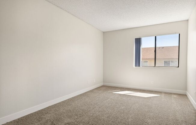 an empty living room with a window