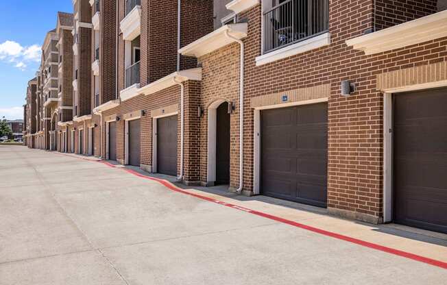 a row of garage doors on a brick building