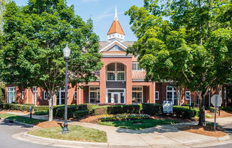 a large brick building with trees in front of it