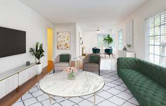A living room with a green sofa and a white coffee table.