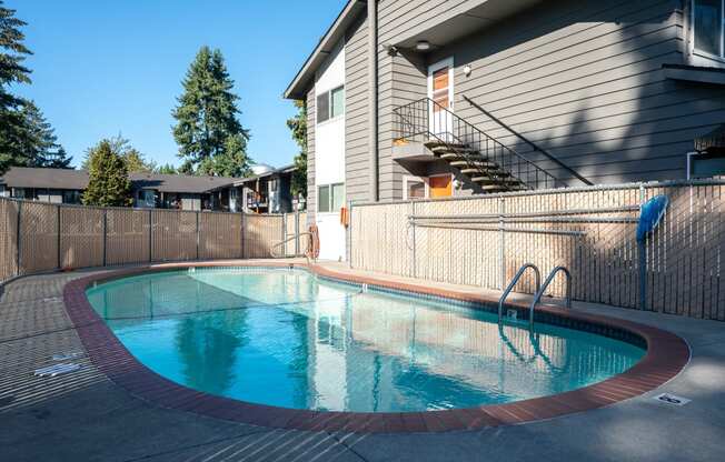 a swimming pool in front of a house