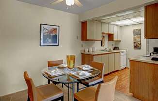 A dining room with a glass table and chairs.