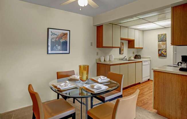 A dining room with a glass table and chairs.