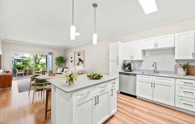 Open-concept kitchen with shaker-style cabinetry, a spacious prep island, and seamless flow into the dining and living areas for easy everyday living.