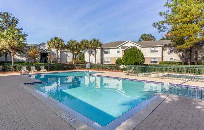 Sparkling blue swimming pool with tanning deck