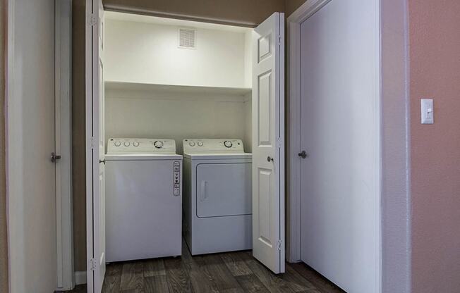 Laundry closet with full sized washer and dryer