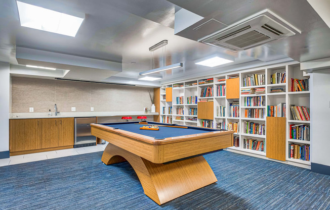 a library with a pool table and bookshelves