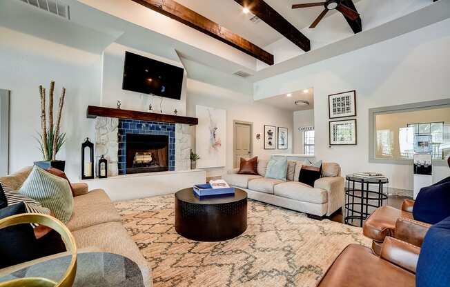 a living room with a fireplace and a flat screen tv