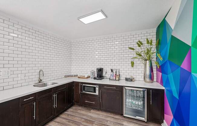 A kitchen with wooden cabinets and a white tiled wall.