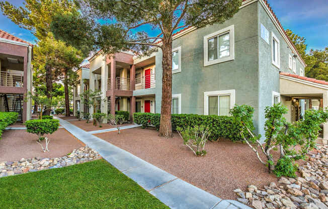 A row of houses with a tree in front of them.