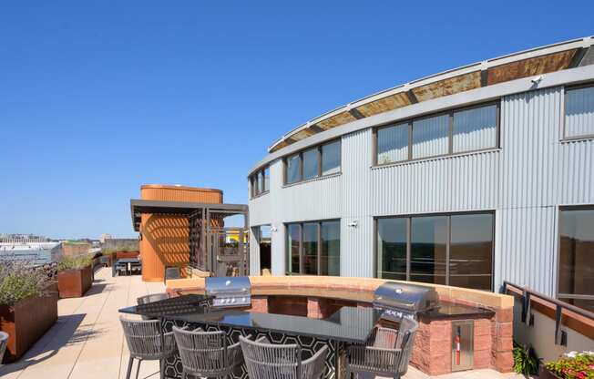 a patio with a table and chairs outside of a building