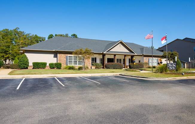 A building with a parking lot in front of it.