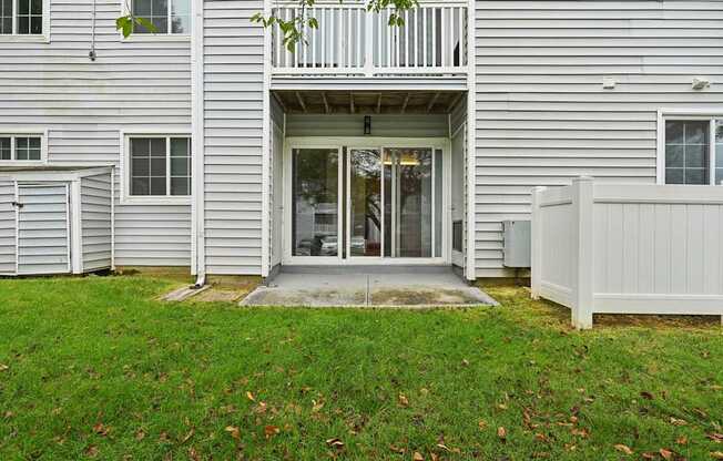 Exterior view into apartment building with patio and a balcony at ReNew Odenton