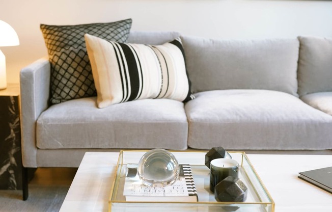 a living room with a couch and a coffee table at The Lively, Jersey City
