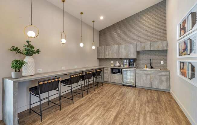 a kitchen with a bar and chairs in front of a counter at Paisley and Pointe Apartments, Las Vegas, Nevada