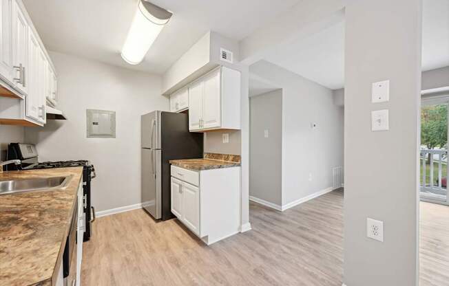 an open kitchen and living room with a stainless steel refrigerator at ReNew Odenton