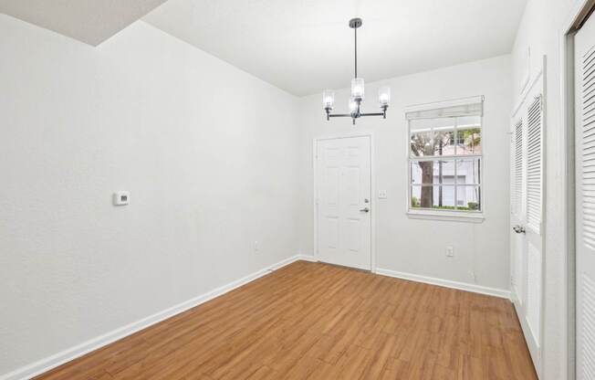 A room with wooden floors and white walls.