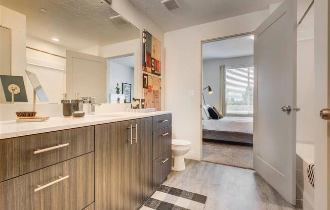 a large bathroom with a toilet and a sink  at Affinity 56 Apartments in West Jordan, Utah