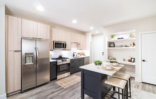 A light-filled kitchen with an oversized island, open shelving, and clean-lined finishes that support everyday cooking and casual dining.