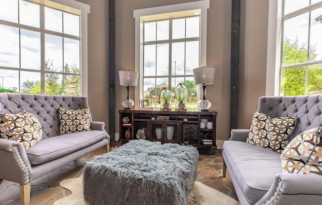 a living room filled with furniture and a large window