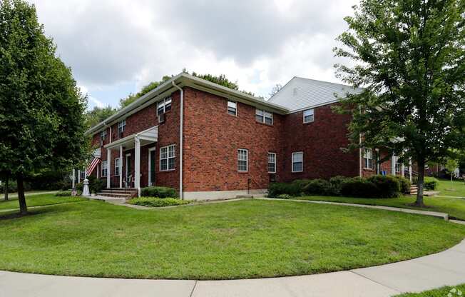 a large brick building with a green lawn in front of it at Nottingham Manor Apartments, Montvale, 07645