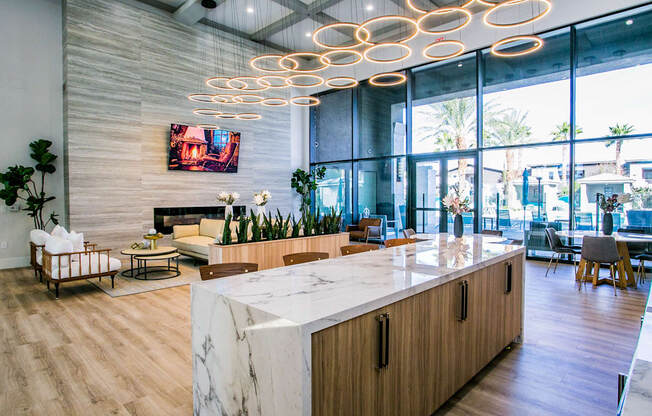 A modern office lobby with a marble counter and wooden furniture.