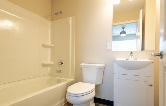 a bathroom with a toilet and a sink and a bath tub