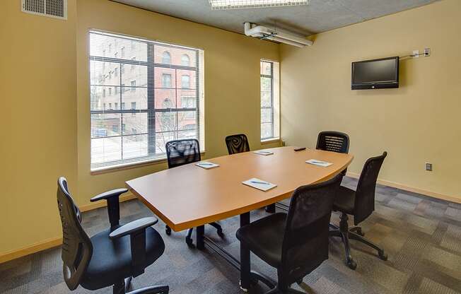 Conference room with oval table and office chairs