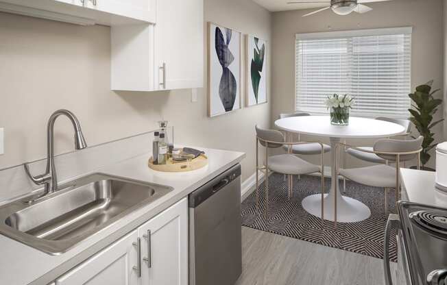 Kitchen and dining space for a circular table with chairs at Canyon Park Apartments, Beaverton, OR 97005