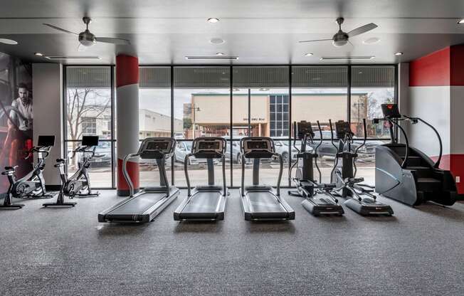 a gym with treadmills and other exercise equipment in front of a window at Mockingbird Flats, Dallas, TX, 75206