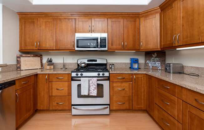 a kitchen with wooden cabinets and stainless steel appliances