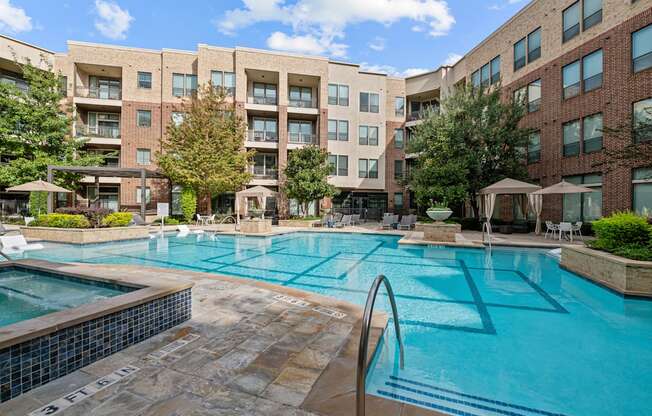 a swimming pool with an apartment building in the background