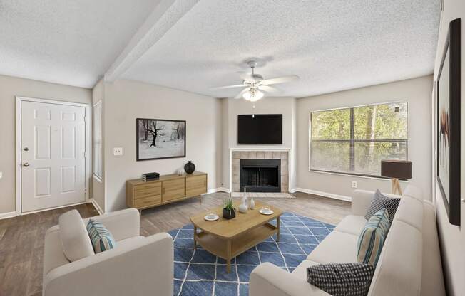 a living room with couches a coffee table and a fireplace